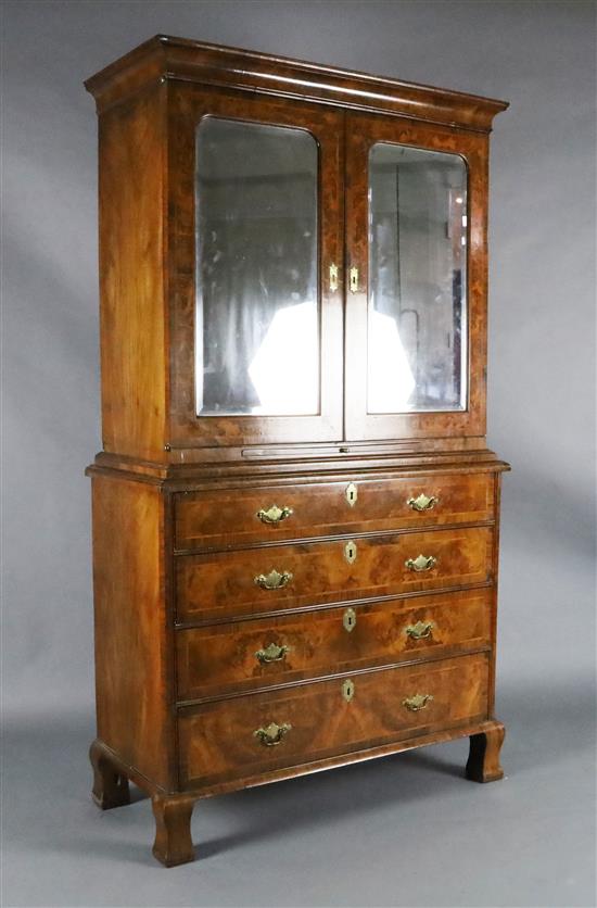 An early 18th century figured and burr walnut cabinet on chest, W.3ft 8in. D.1ft 8in. H.6ft 6.5in.